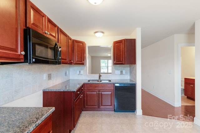 169 Abigail Ln, Locust, NC 28097 - kitchen with black appliances, dark stone countertops, and decorative backsplash