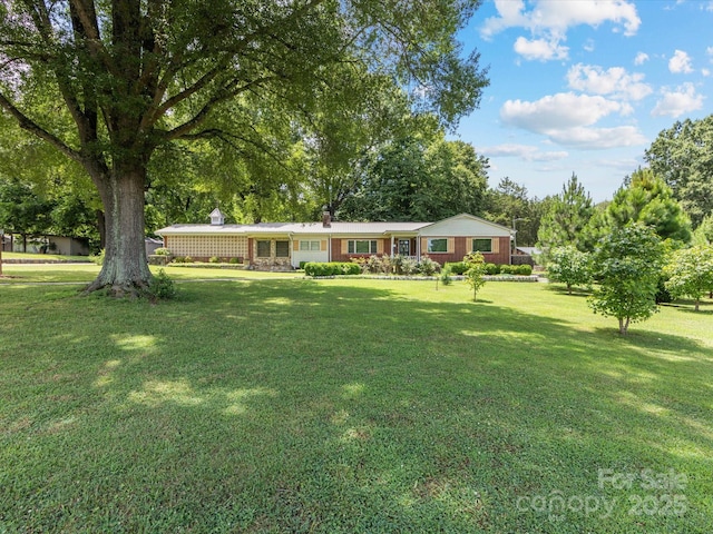 209 11th St, Spencer, NC 28159 - ranch-style house featuring a front lawn and a chimney