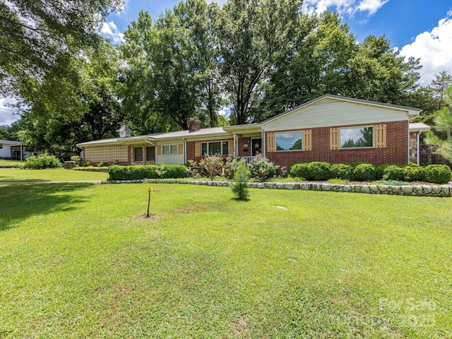 209 11th St, Spencer, NC 28159 - ranch-style house with brick siding, a front lawn, and a chimney
