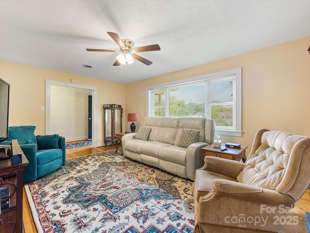 209 11th St, Spencer, NC 28159 - living area with a ceiling fan and wood finished floors