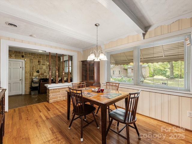 209 11th St, Spencer, NC 28159 - dining area with beamed ceiling, light wood-type flooring, and a chandelier