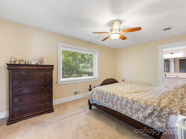 209 11th St, Spencer, NC 28159 - bedroom with light carpet, a textured ceiling, ceiling fan, and ensuite bath