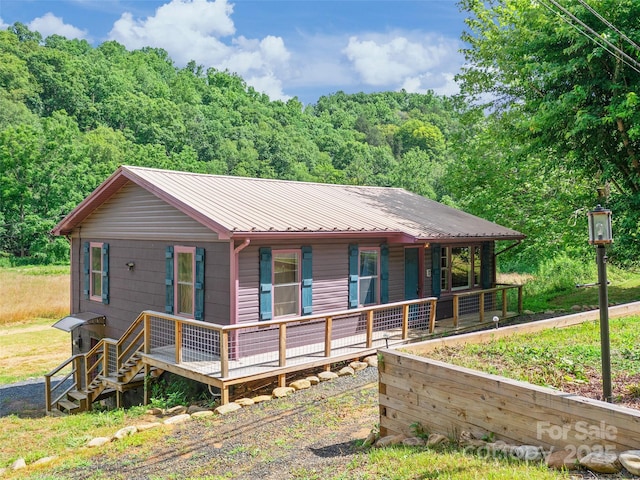 1767 N 226th Hwy, Bakersville, NC 28705 - view of front of property with a metal roof, a porch, and a forest view