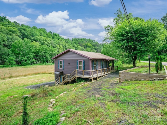 1767 N 226th Hwy, Bakersville, NC 28705 - view of front of house with a view of trees, a front yard, a metal roof, and covered porch