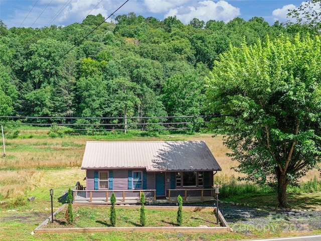 1767 N 226th Hwy, Bakersville, NC 28705 - view of front of house featuring covered porch, a metal roof, and a view of trees