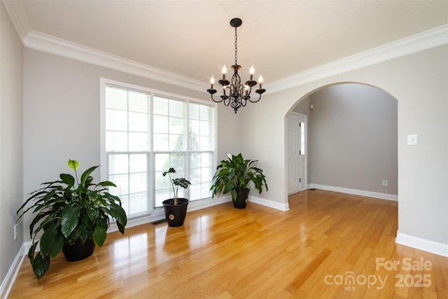1309 Stonewyck Dr, Salisbury, NC 28146 - unfurnished room with arched walkways, crown molding, light wood-style flooring, and a chandelier