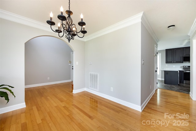 1309 Stonewyck Dr, Salisbury, NC 28146 - unfurnished dining area with arched walkways, a chandelier, light wood-type flooring, and ornamental molding