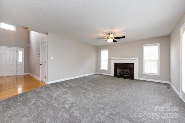 1309 Stonewyck Dr, Salisbury, NC 28146 - unfurnished living room with carpet, a ceiling fan, and a high end fireplace