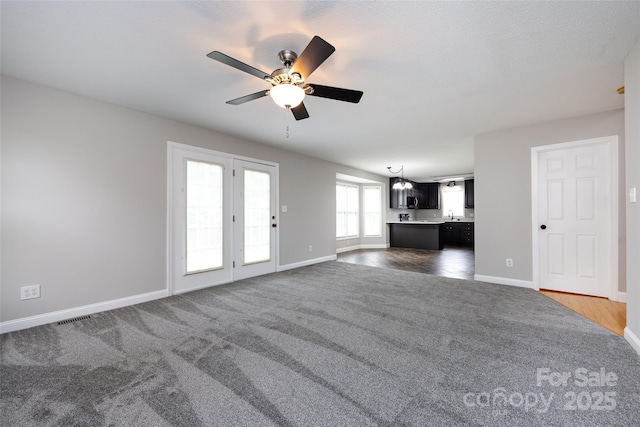 1309 Stonewyck Dr, Salisbury, NC 28146 - unfurnished living room with carpet floors and a ceiling fan