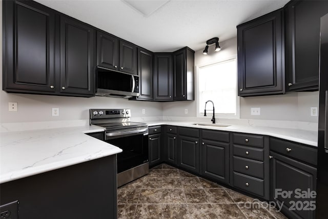1309 Stonewyck Dr, Salisbury, NC 28146 - kitchen with stainless steel appliances, dark stone finish floors, light stone counters, and dark cabinetry