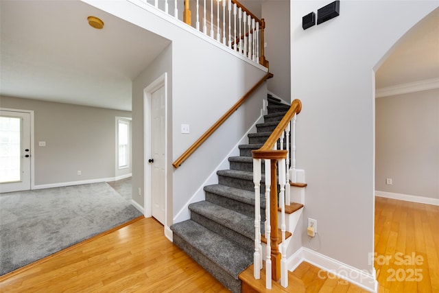 1309 Stonewyck Dr, Salisbury, NC 28146 - staircase with arched walkways, healthy amount of natural light, wood finished floors, and ornamental molding