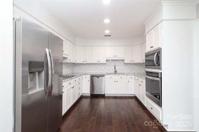 4350 Old Saybrook Ct, Charlotte, NC 28211 - kitchen with stainless steel appliances, dark wood-style flooring, white cabinetry, recessed lighting, and crown molding