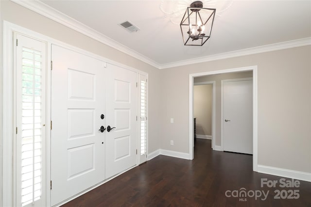 4350 Old Saybrook Ct, Charlotte, NC 28211 - foyer entrance with a chandelier, ornamental molding, and dark wood-style flooring
