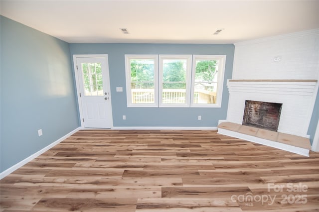 113 Oakleaf Dr, Landrum, SC 29356 - unfurnished living room featuring wood finished floors and a fireplace