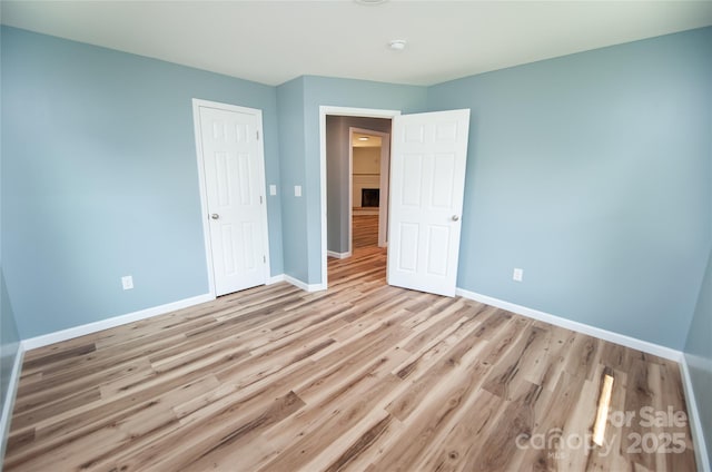 113 Oakleaf Dr, Landrum, SC 29356 - unfurnished bedroom with baseboards and wood finished floors
