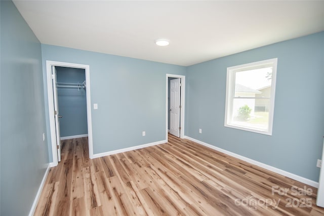 113 Oakleaf Dr, Landrum, SC 29356 - unfurnished bedroom with light wood-style flooring and a spacious closet