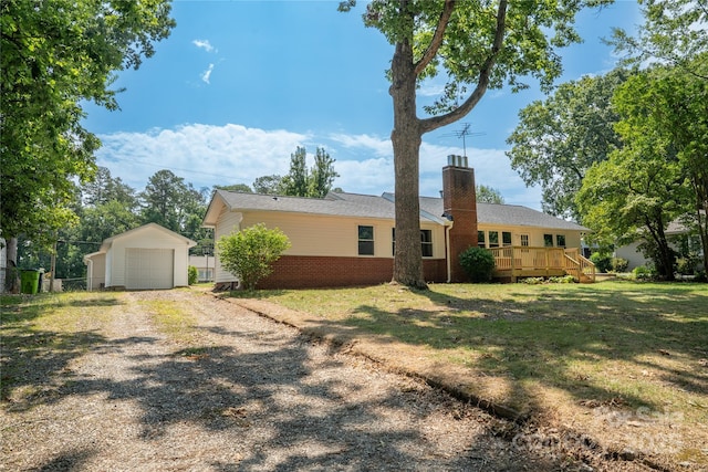 113 Oakleaf Dr, Landrum, SC 29356 - view of front of home featuring a garage, a chimney, an outdoor structure, gravel driveway, and a wooden deck
