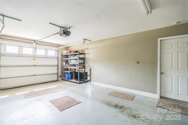 211 Abee St, Morganton, NC 28655 - garage featuring baseboards and a garage door opener
