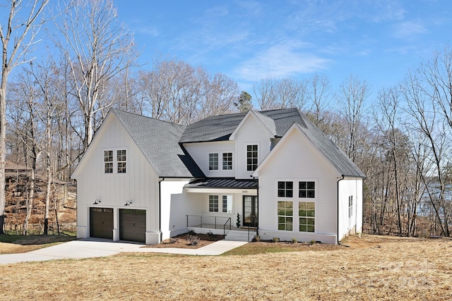 3830 Mill Run, Terrell, NC 28682 - view of front of home featuring roof with shingles, a garage, driveway, a standing seam roof, and covered porch