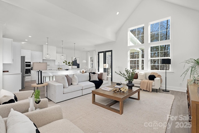 3830 Mill Run, Terrell, NC 28682 - living room with light wood-style flooring, recessed lighting, plenty of natural light, and a towering ceiling