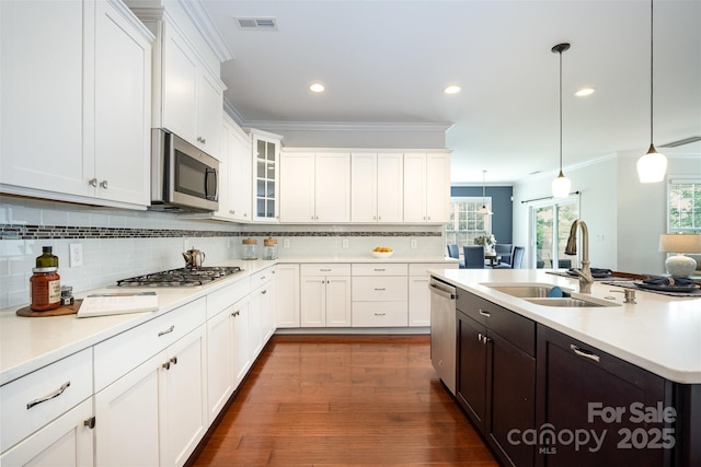 3021 Henshaw Rd, Waxhaw, NC 28173 - kitchen with ornamental molding, white cabinetry, light countertops, decorative backsplash, and glass insert cabinets