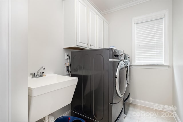 3021 Henshaw Rd, Waxhaw, NC 28173 - laundry area featuring washing machine and dryer, ornamental molding, cabinet space, and light tile patterned floors