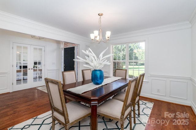 444 Cottonfield Cir, Waxhaw, NC 28173 - dining area with wood finished floors, a chandelier, crown molding, french doors, and a decorative wall