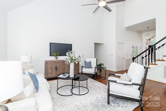 444 Cottonfield Cir, Waxhaw, NC 28173 - living area featuring a towering ceiling, wood finished floors, stairway, a chandelier, and ceiling fan