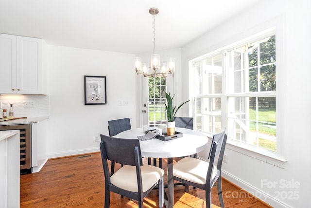 444 Cottonfield Cir, Waxhaw, NC 28173 - dining room with a chandelier, beverage cooler, and wood finished floors
