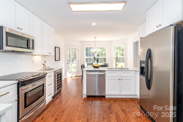 444 Cottonfield Cir, Waxhaw, NC 28173 - kitchen featuring appliances with stainless steel finishes, dark wood-type flooring, light countertops, a chandelier, and recessed lighting