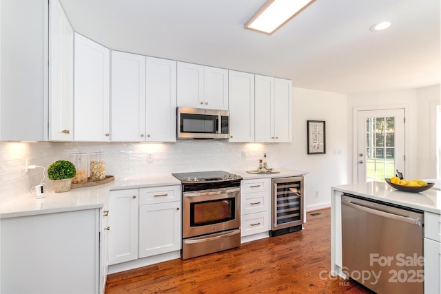 444 Cottonfield Cir, Waxhaw, NC 28173 - kitchen with stainless steel appliances, beverage cooler, decorative backsplash, white cabinetry, and recessed lighting