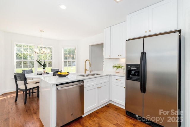 444 Cottonfield Cir, Waxhaw, NC 28173 - kitchen featuring stainless steel appliances, a peninsula, white cabinetry, a chandelier, and light countertops
