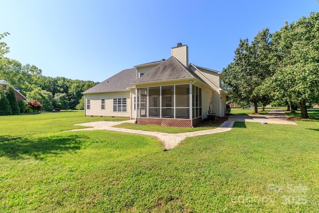 444 Cottonfield Cir, Waxhaw, NC 28173 - back of house with a sunroom, a yard, crawl space, a chimney, and roof with shingles