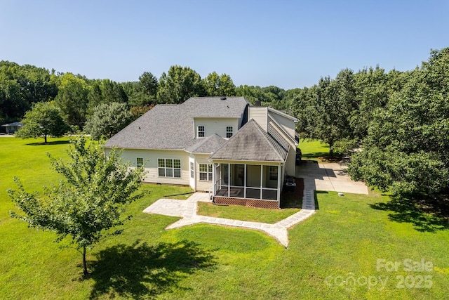 444 Cottonfield Cir, Waxhaw, NC 28173 - rear view of house with a sunroom, a yard, and roof with shingles