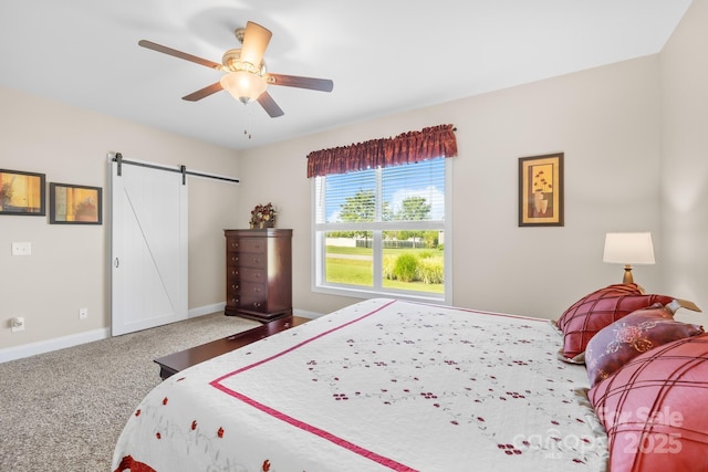 240 Red Cedar Rd, Mooresville, NC 28115 - bedroom with a barn door, ceiling fan, and carpet flooring