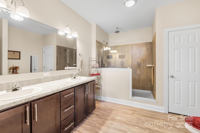 240 Red Cedar Rd, Mooresville, NC 28115 - bathroom with a tile shower, double vanity, and wood finished floors