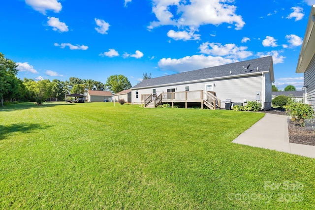 240 Red Cedar Rd, Mooresville, NC 28115 - back of property featuring stairway, a wooden deck, and a lawn
