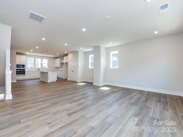 7004 Impulse Ct, Charlotte, NC 28205 - unfurnished living room with recessed lighting and light wood-type flooring
