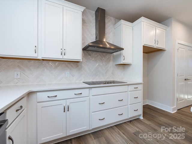 7004 Impulse Ct, Charlotte, NC 28205 - kitchen featuring wall chimney exhaust hood, white cabinets, tasteful backsplash, and light countertops