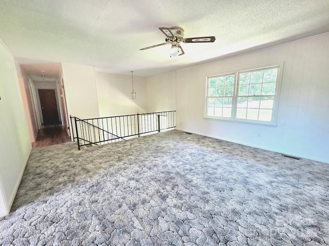717 2nd St SW, Conover, NC 28613 - unfurnished room with a textured ceiling, carpet flooring, and a ceiling fan