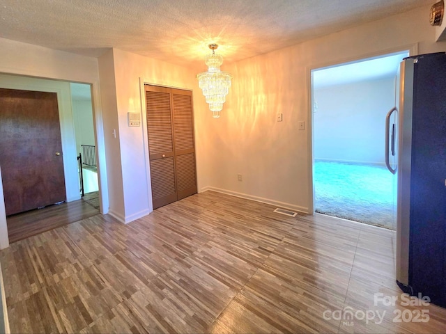 717 2nd St SW, Conover, NC 28613 - unfurnished dining area featuring a chandelier and wood finished floors