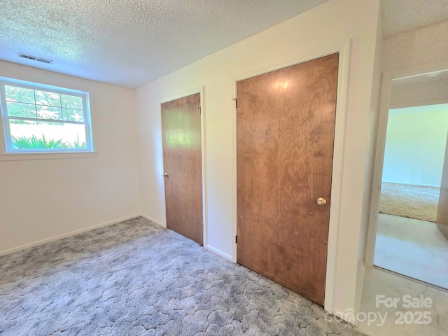 717 2nd St SW, Conover, NC 28613 - unfurnished bedroom featuring carpet flooring and a textured ceiling
