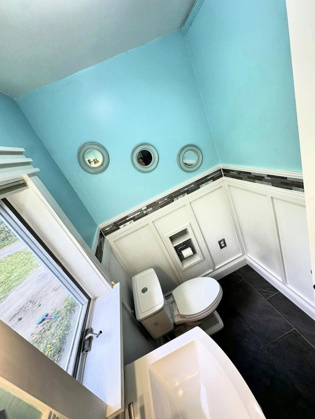 491 W Main St, Waldoboro, ME 04572 - bathroom featuring a decorative wall, wainscoting, and toilet