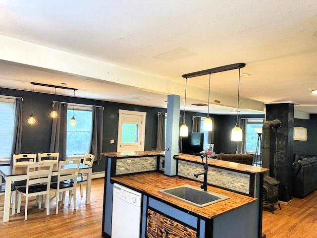 491 W Main St, Waldoboro, ME 04572 - kitchen with butcher block countertops, white dishwasher, a sink, wood finished floors, and open floor plan