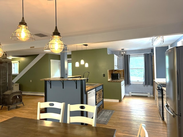 491 W Main St, Waldoboro, ME 04572 - kitchen with freestanding refrigerator, gas stove, a baseboard radiator, and a sink