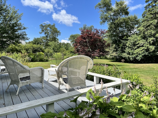 wooden terrace with a lawn