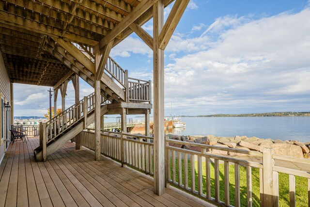 wooden deck featuring a water view