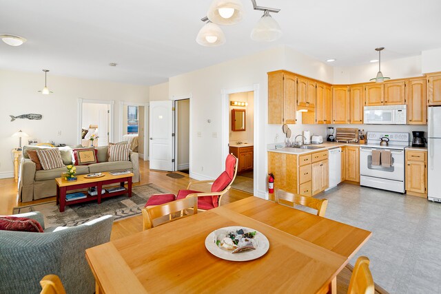 dining room featuring sink and light wood-type flooring