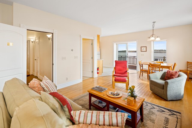 living room featuring light hardwood / wood-style floors and a chandelier