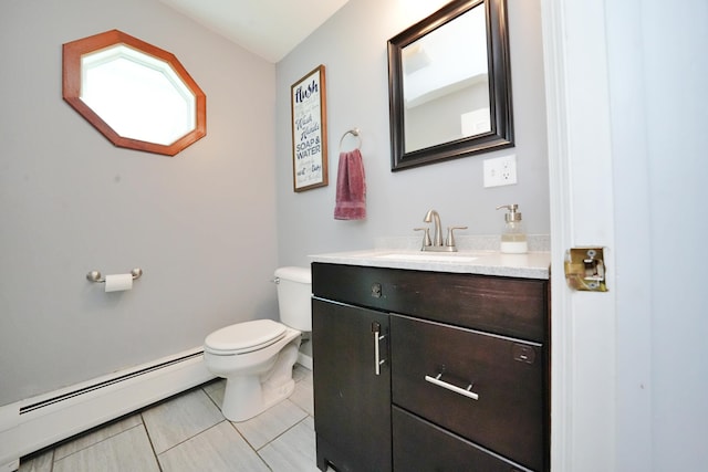 428 Main St, Orono, ME 04473 - bathroom featuring a baseboard heating unit, toilet, vanity, and tile patterned flooring